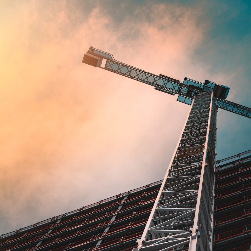 low angle photography of gray tower crane
